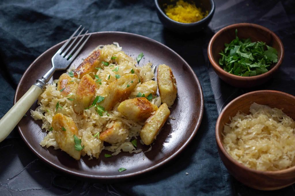 Polish whole wheat kopytka (dumplings) with sauerkraut.