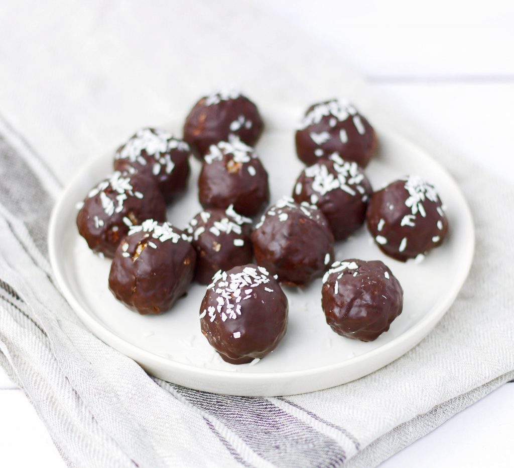 Vegan coconut and almond truffles covered with dark chocolate.